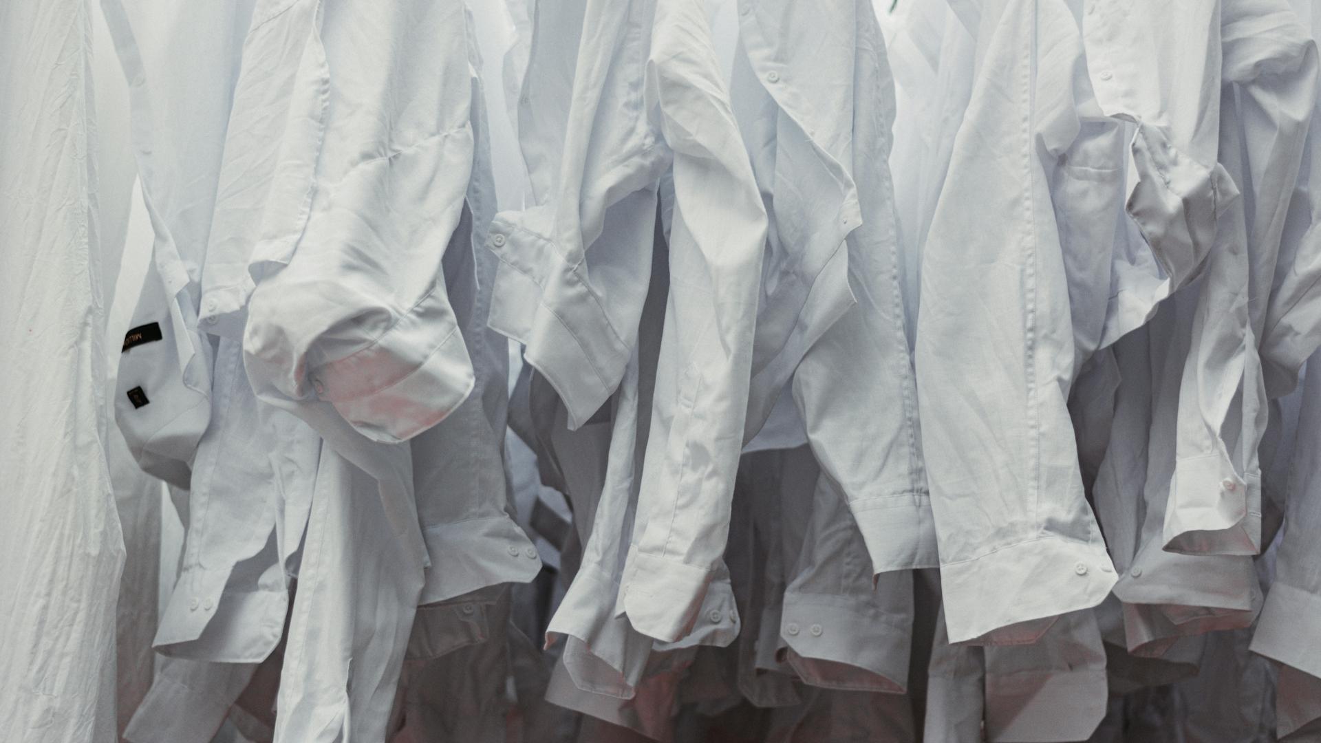 A collection of white shirts hanging neatly